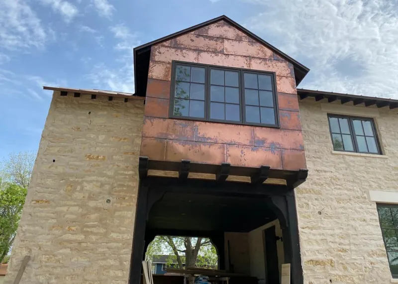 Copper metal panel facade on a stone building for Skylight Installation in Huntsville