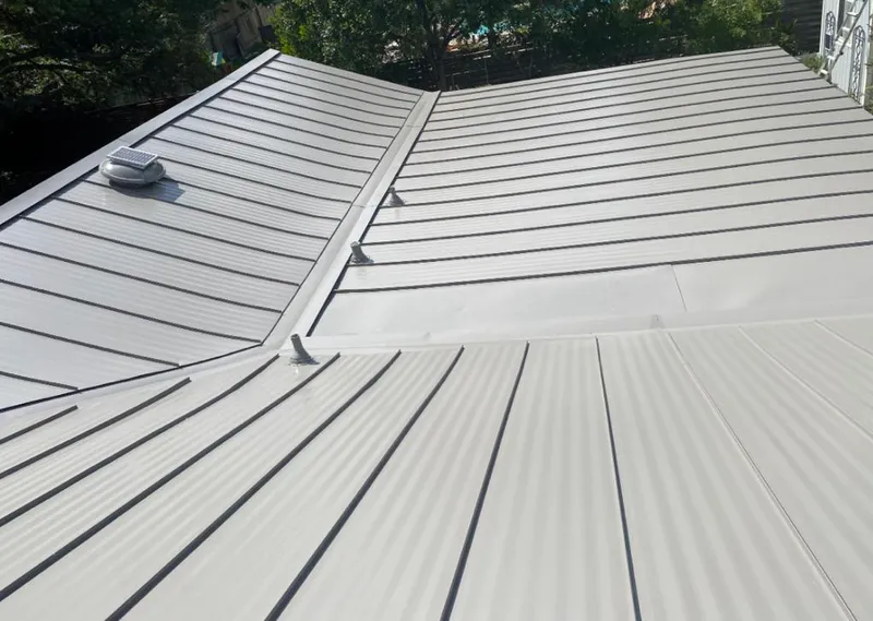 Solar attic fan installed on a metal roof for Roof Ventilation in Huntsville